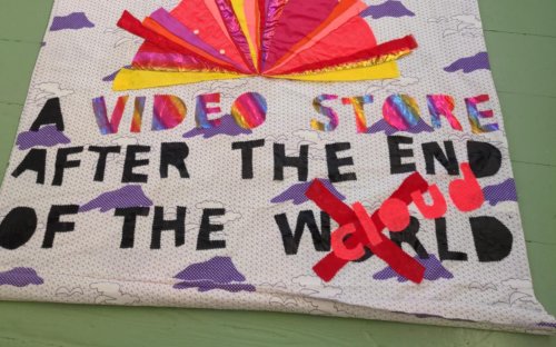 Hand-sewn banner: "A videostore after the end of the world/Cloud"