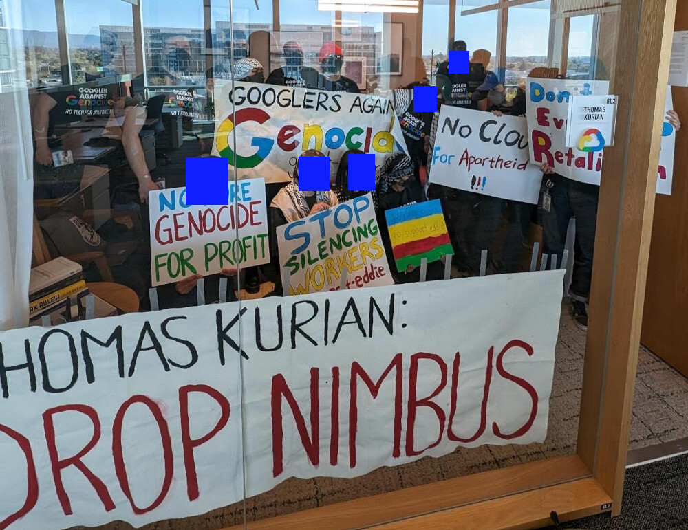 Google workers hold up banners: Googlers against Genocide, Thomas Kurian Drop Nimbus