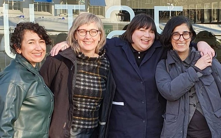 A snapshot of four smiling persons, with their arms around each other. From left to right: Miriyam Aouragh, Femke Snelting, Helen V. Pritchard, and Seda Gürses