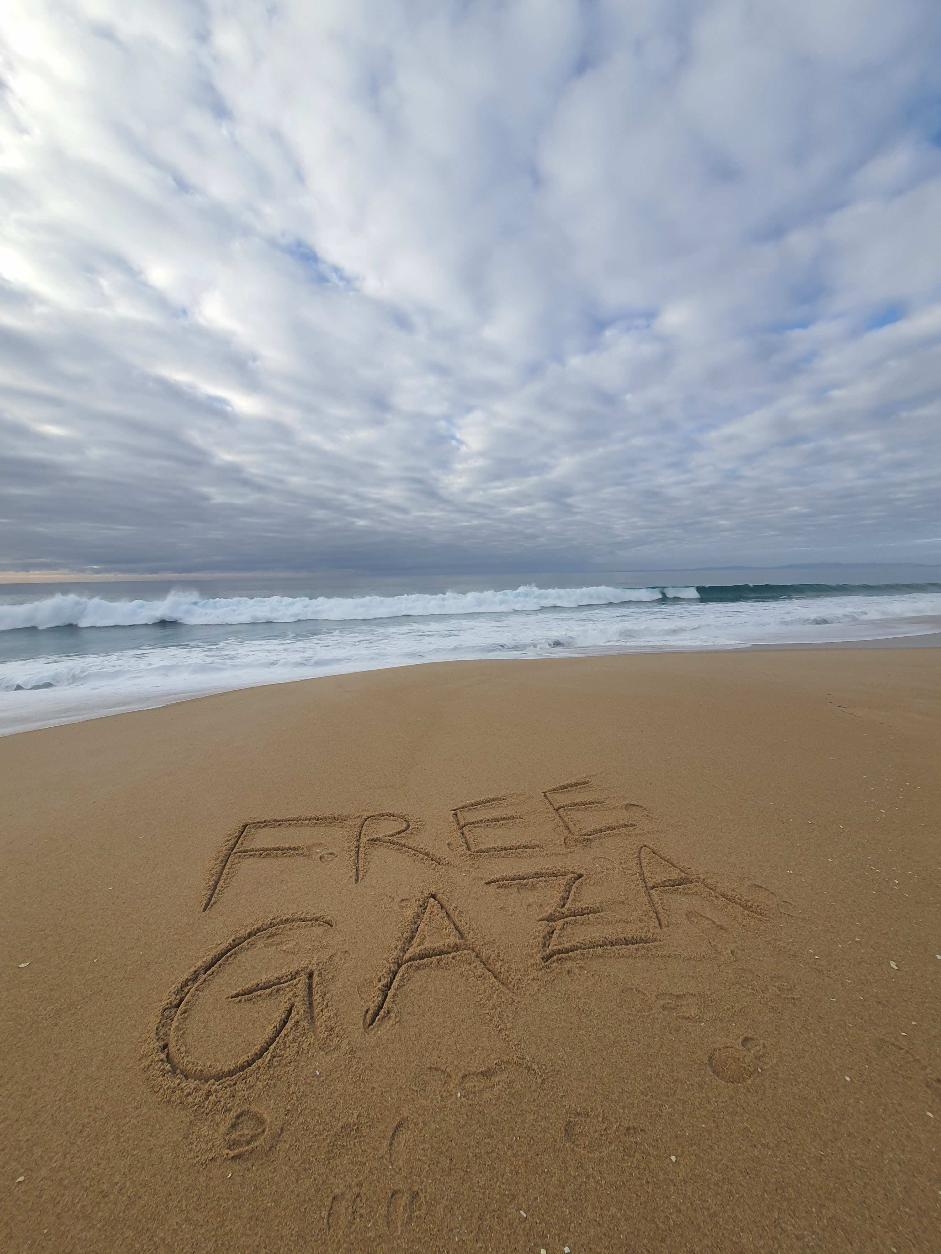 The Beach in Portugal, Cloudy December Sky, Big Surfable Waves, someone (me hihi) wrote in the Sand: "Free Gaza"