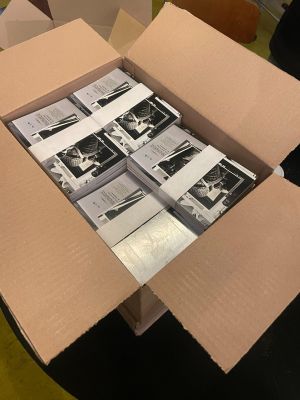 a cardboard box filled with stacks of postcards