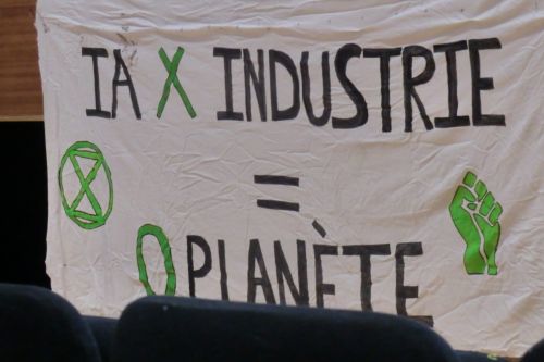 Paris, February 2025. Banner attached to the stage at the Anti-AI summit organized by anti-tech resistance in the Annexe de la bourse du travail: "IA x industry = 0 planet". The meeting could not take place in its original location and had been quickly moved to this venue. Later, in Grenoble, we start to understand more of the tensions around this group. Their anti-tech approach is based in an essentialist understanding of nature, at times anti-feminist, and bleeding into anti-trans statements.