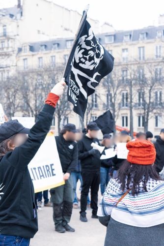 Paris, February 2025. Anti-AI demo behind the Grand Palais, where the AI Action summit will be held the next days. After 20 minutes, the gathering was broken up by the police. With red hat: 'Marie Capucine' (she said: "I am obviously not called that way"). We met her in front of the Grand Palais, she was like us looking for the location of the demo. Marie Capucine explained she joined the demo because "Someone has to say no to Musk and Trump and their plans for Gaza". Picture published by Anti-Tech-Resistance.