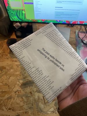a stack of postcards, wrapped in a sheet of texts